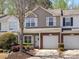 Charming two-story townhome with a well-manicured lawn and an attached one-car garage at 475 Delta Dr, Fort Mill, SC 29715