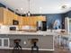 Open concept kitchen with a center island, stainless steel appliances, and dark blue accent wall at 475 Delta Dr, Fort Mill, SC 29715