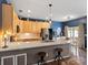 Open kitchen boasts a large island with bar seating, light wood cabinets, and stainless steel appliances at 475 Delta Dr, Fort Mill, SC 29715