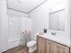 Bright bathroom featuring a shower-tub, toilet, vanity, and wood-look flooring at 501 Mt. Wesley Church Rd, Hiddenite, NC 28636