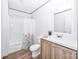Bright bathroom featuring a shower-tub, toilet, vanity, and wood-look flooring at 501 Mt. Wesley Church Rd, Hiddenite, NC 28636