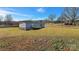 Spacious yard surrounds a cozy single-story home with a charming back porch at 501 Mt. Wesley Church Rd, Hiddenite, NC 28636
