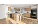 Bright kitchen featuring an island with a white countertop and wooden cabinetry at 501 Mt. Wesley Church Rd, Hiddenite, NC 28636