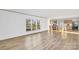 Bright living room boasts wood floors, large windows, and views of the kitchen with eat-in island at 501 Mt. Wesley Church Rd, Hiddenite, NC 28636