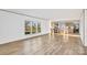 Bright living room boasts wood floors, large windows, and views of the kitchen with eat-in island at 501 Mt. Wesley Church Rd, Hiddenite, NC 28636