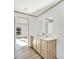 Bathroom vanity featuring double sinks, wood cabinets, neutral tones, and modern fixtures at 525 Mt. Wesley Church Rd, Hiddenite, NC 28636