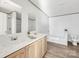 Bright bathroom featuring double sinks, soaking tub, wood-look flooring, and neutral paint at 525 Mt. Wesley Church Rd, Hiddenite, NC 28636