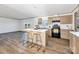 Modern kitchen with an island, seating, stainless appliances, and wood cabinets in an open layout at 525 Mt. Wesley Church Rd, Hiddenite, NC 28636