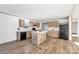 Spacious kitchen with an island, wood cabinetry, stainless steel appliances, and wood-look floors at 525 Mt. Wesley Church Rd, Hiddenite, NC 28636