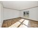 Inviting living room showcasing wood-look floors, a window for natural light, and neutral wall colors at 525 Mt. Wesley Church Rd, Hiddenite, NC 28636