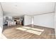 Open-concept living space combining the kitchen and living room with wood-look flooring and neutral tones at 525 Mt. Wesley Church Rd, Hiddenite, NC 28636