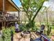 Outdoor seating around a stone fire pit in landscaped back yard near covered patio at 5301 Greyfriar Ct, Waxhaw, NC 28173