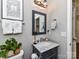 Cozy bathroom featuring a gray vanity with a marble countertop and decorative accessories at 5301 Greyfriar Ct, Waxhaw, NC 28173