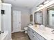 Bright bathroom features dual sinks, a long vanity with modern lighting and wood look flooring at 5301 Greyfriar Ct, Waxhaw, NC 28173