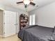 Comfortable bedroom showcasing a full-sized bed with a ceiling fan and a bookshelf at 5301 Greyfriar Ct, Waxhaw, NC 28173