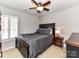 Well-lit bedroom featuring a full-sized bed with a ceiling fan and natural light at 5301 Greyfriar Ct, Waxhaw, NC 28173