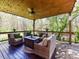 Covered deck with ceiling fan and outdoor seating with scenic backyard at 5301 Greyfriar Ct, Waxhaw, NC 28173