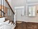 Elegant foyer with hardwood floors, staircase, wainscoting, and shuttered windows at 5301 Greyfriar Ct, Waxhaw, NC 28173