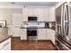 Modern kitchen features granite countertops, white cabinets, and stainless appliances at 5301 Greyfriar Ct, Waxhaw, NC 28173