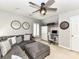 Living room features a ceiling fan, shutters, and large sectional sofa and desk space at 5301 Greyfriar Ct, Waxhaw, NC 28173