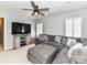 Living room features a ceiling fan, shutters, and large sectional sofa at 5301 Greyfriar Ct, Waxhaw, NC 28173