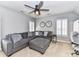 Living room features a ceiling fan, shutters, and sectional sofa at 5301 Greyfriar Ct, Waxhaw, NC 28173
