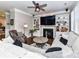 Comfortable living room featuring a fireplace, built-in shelving, and hardwood floors at 5301 Greyfriar Ct, Waxhaw, NC 28173