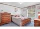 Comfortable bedroom with neutral walls, wood furniture, and a sunny window at 6575 Charlotte Hwy, York, SC 29745