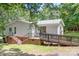 View of the rear exterior of a ranch home with a ramp, small porch, and steps leading to the backyard at 6575 Charlotte Hwy, York, SC 29745