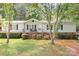 Charming single-story home with a well-maintained front yard, porch, and lush green trees, perfect for peaceful suburban living at 6575 Charlotte Hwy, York, SC 29745