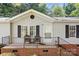 Inviting front porch with seating area and brick foundation at 6575 Charlotte Hwy, York, SC 29745