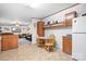 Eat-in kitchen featuring wood cabinets, tile flooring, and a dining nook, perfect for casual Gathering meals at 6575 Charlotte Hwy, York, SC 29745