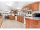 A functional kitchen with wood cabinets, white appliances, and a view into the dining area, creating a cozy cooking space at 6575 Charlotte Hwy, York, SC 29745