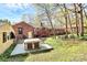 Backyard with a hot tub and table and chairs, with mature trees at 7034 Leaves Ln, Charlotte, NC 28213