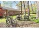 Backyard features a fire pit, seating area, and mature trees at 7034 Leaves Ln, Charlotte, NC 28213