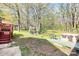 Backyard with a hot tub, table and chairs, with a mature tree line at 7034 Leaves Ln, Charlotte, NC 28213