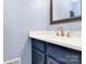 Bathroom vanity featuring a white countertop and gold faucet at 7034 Leaves Ln, Charlotte, NC 28213