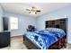 Bedroom boasts light blue walls, a ceiling fan, wood-look floors, and a bed with a blue comforter at 7034 Leaves Ln, Charlotte, NC 28213