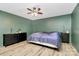 Bedroom featuring hardwood floors, ceiling fan, and ample space at 7034 Leaves Ln, Charlotte, NC 28213