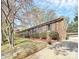 Beautiful brick home exterior with well-maintained landscaping and a detached garage at 7034 Leaves Ln, Charlotte, NC 28213