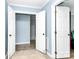 Open foyer with neutral paint, white doors, decorative tile flooring and hardwood flooring at 7034 Leaves Ln, Charlotte, NC 28213