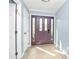 Inviting foyer with a purple front door, decorative tile flooring, and neutral paint at 7034 Leaves Ln, Charlotte, NC 28213