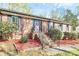 Charming brick home featuring a beautiful front entrance with a decorative purple door and landscaped yard at 7034 Leaves Ln, Charlotte, NC 28213