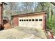 Exterior shot of a brick two-car garage with a stairway at 7034 Leaves Ln, Charlotte, NC 28213