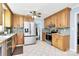 Modern kitchen featuring stainless steel appliances, granite countertops, and wood cabinets at 7034 Leaves Ln, Charlotte, NC 28213