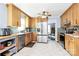 Bright kitchen featuring stainless steel appliances, wood cabinets, and a light tile floor at 7034 Leaves Ln, Charlotte, NC 28213