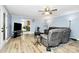 Open-concept living room area with hardwood floors and access to the kitchen at 7034 Leaves Ln, Charlotte, NC 28213