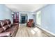 Bright living room with hardwood floors and a dining room view at 7034 Leaves Ln, Charlotte, NC 28213
