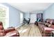 Spacious living room area with a desk, hardwood floors and natural light at 7034 Leaves Ln, Charlotte, NC 28213