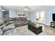 Comfortable living room with a grey brick fireplace and a ceiling fan at 7034 Leaves Ln, Charlotte, NC 28213